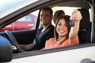image of a woman holding up a car key